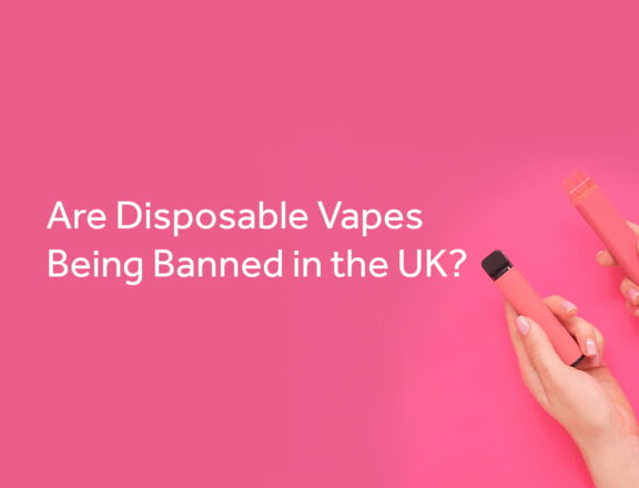 Pink background with the words are disposable vapes being banned in the UK? Behind the text is an image of a two hands with a vape in each.