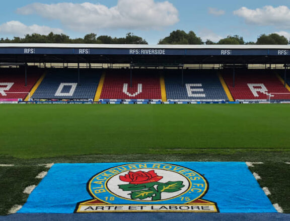 Blackburn Rovers' Pitch with stadium seating in the background.