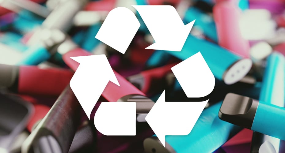 A background of many disposabel vapes with the recycling log of turning arrows in the foreground.