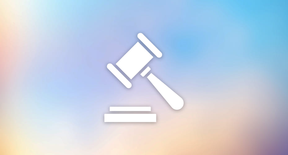 A white icon of a judge's gavel and sounding block set against a gradient background. The image symbolizes law, legislation, and regulations.