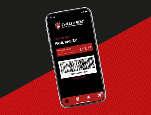 Blak and red background with a smart phone with the Totally Wicked Store App on the screen