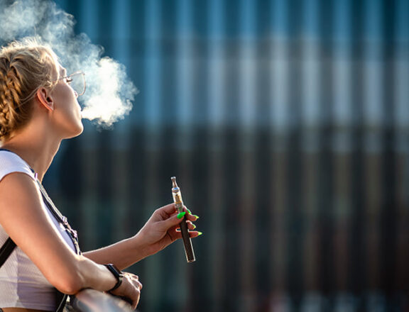 person vaping seated outside