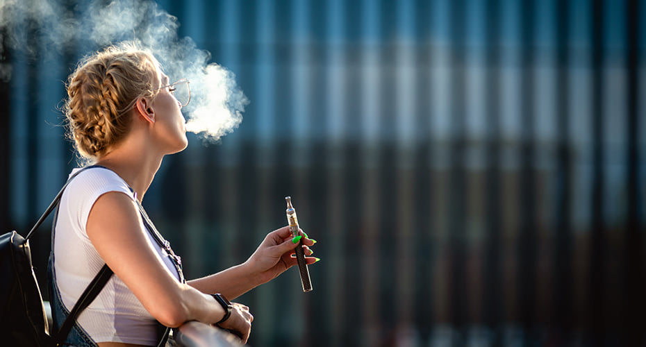 person vaping seated outside